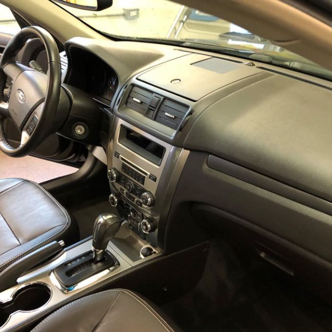 A cleaned car dashboard and center console.